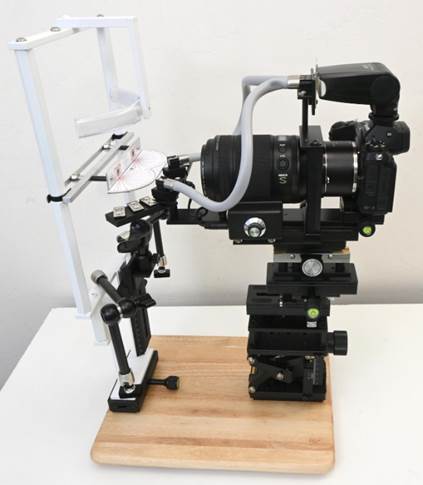 A camera on a wooden surface
Description automatically generated