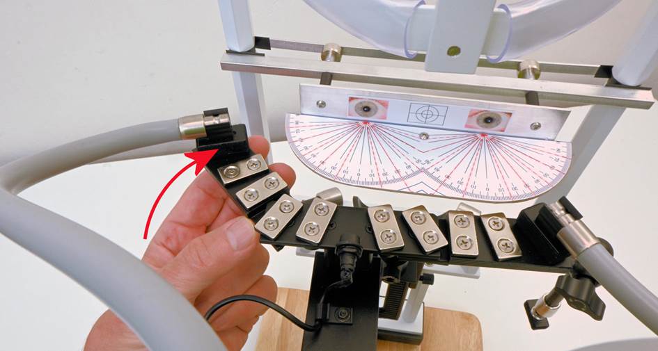 A hand holding a metal piece
Description automatically generated