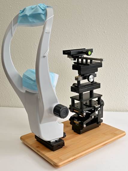 A microscope with a mask on it
Description automatically generated