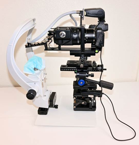 A camera on a white stand
Description automatically generated