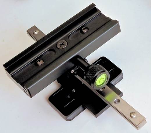 A black metal object with a green light
Description automatically generated